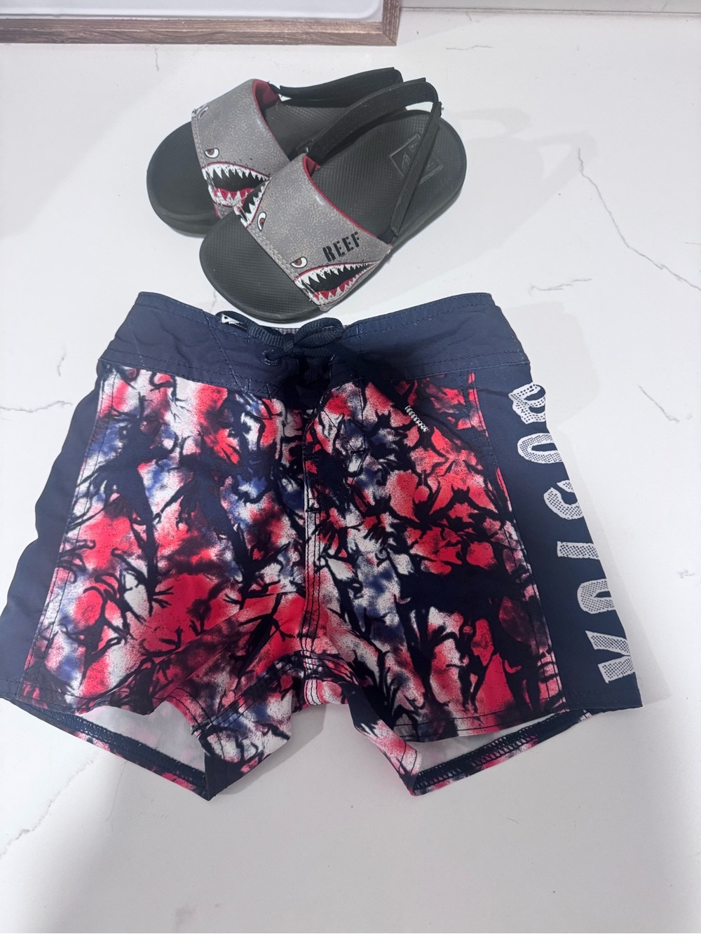 Volcom toddler swim trunks and reef sandals